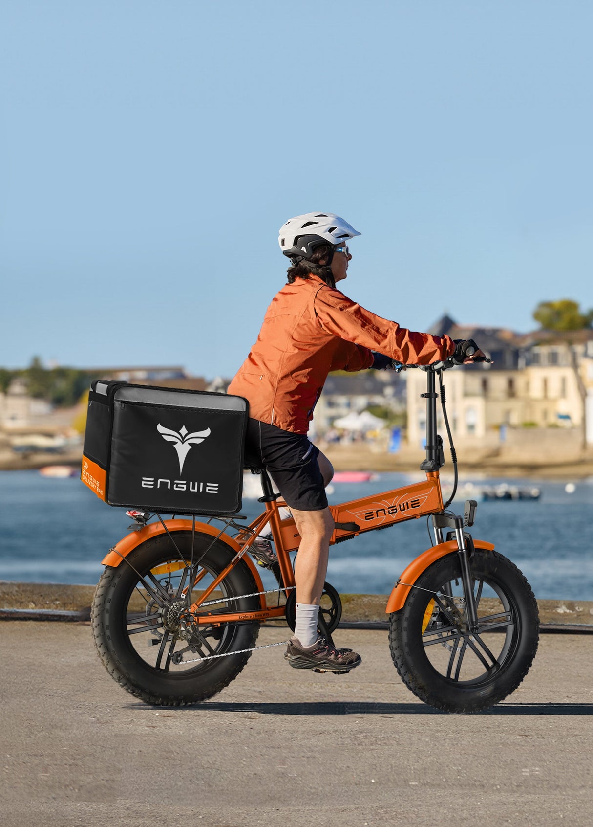 a person riding an engwe ep-2 boost electric bicycle with a takeaway box